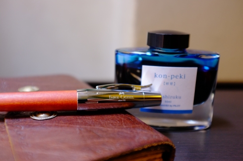 My smoothest-writing (and most treasured) pen, the Faber-Castell e-motion with pearwood; my original Bibliographica journal; and Iroshizuku kon-peki ink. 